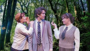 Three cast members from "As You Like It" engaged in dialogue